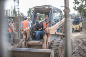 trabajador de la construcción conduciendo una excavadora en un sitio de construcción
